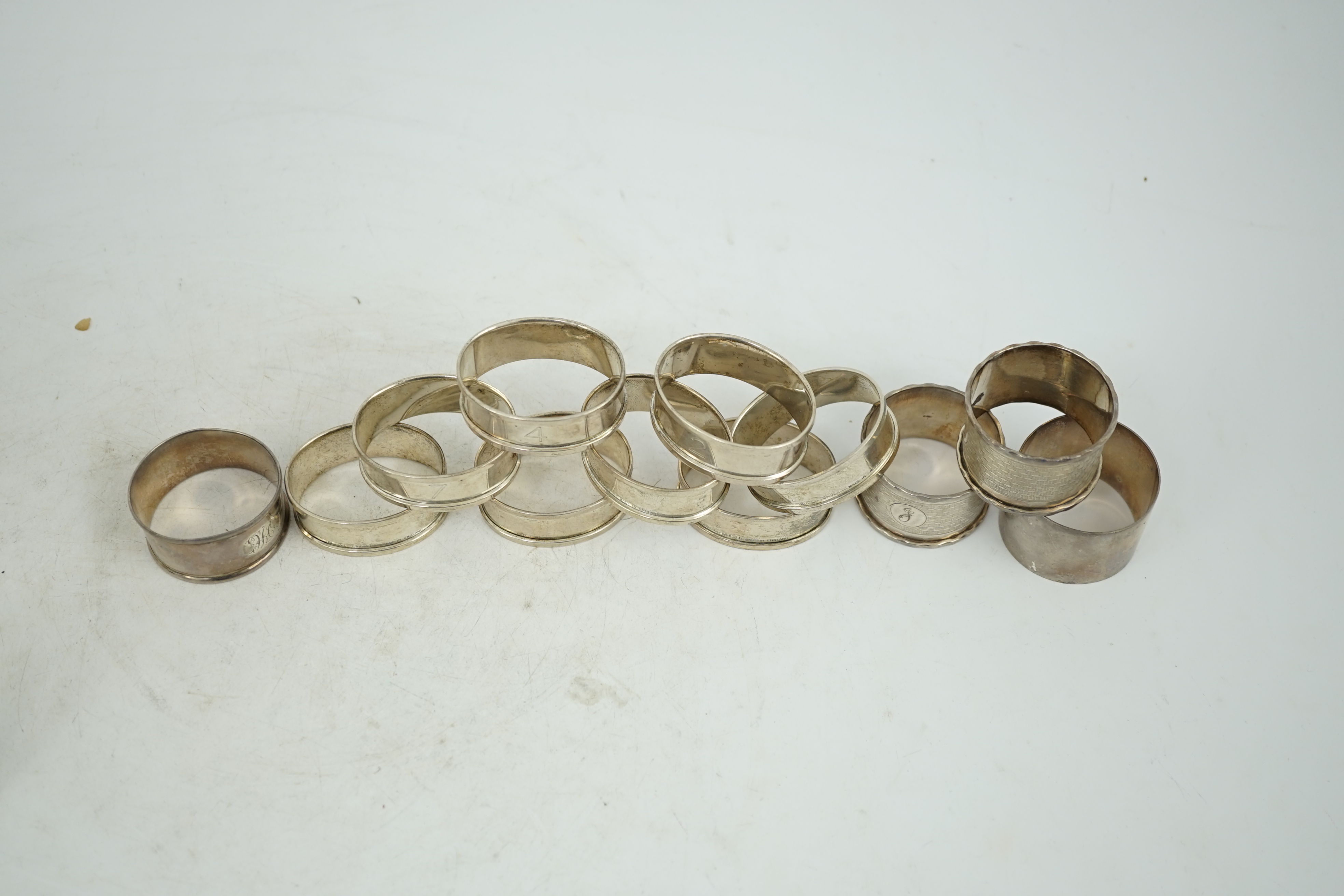 A matched set of eight early 1930's silver napkin rings and four other silver napkin rings including a pair, Birmingham, 1929, 5.3oz.